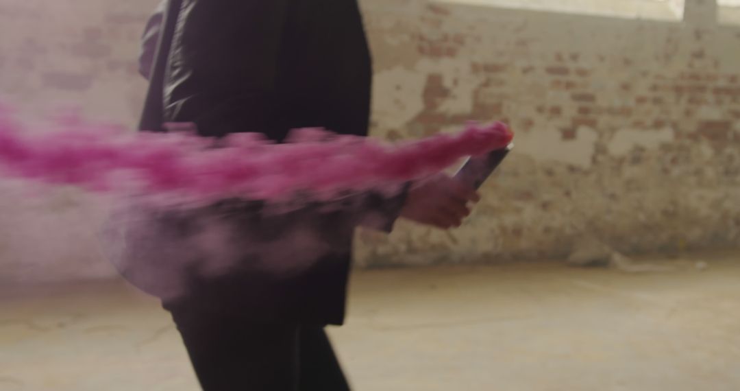 Dramatic Motion of Person Indoors with Vivid Pink Smoke Trail