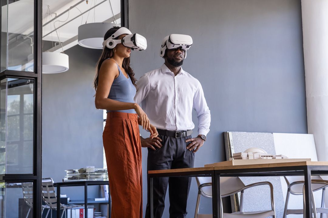 Diverse Professionals Using VR Headsets in Design Studio for Architectural Model