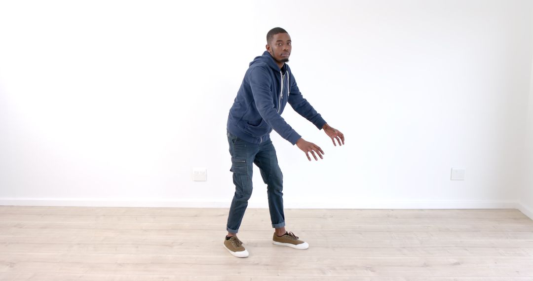 Man Practicing Dance Moves in Minimalist Space