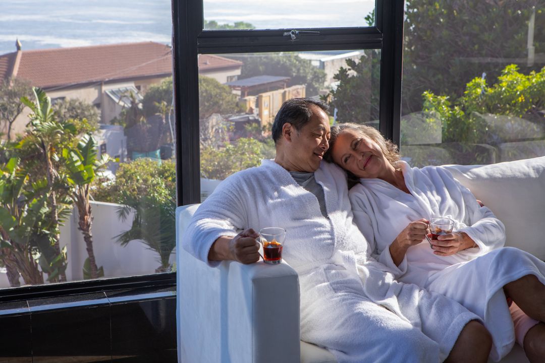 Diverse Senior Couple Relaxing Indoors with Warm Beverages