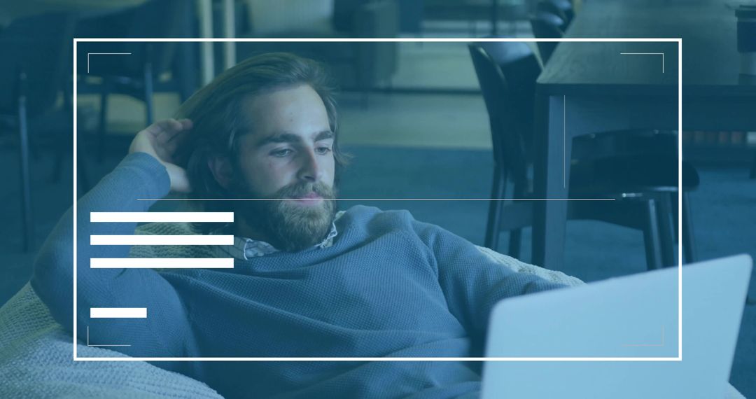 Professionally Relaxed Worker Focusing on Laptop in Minimalist Lounge