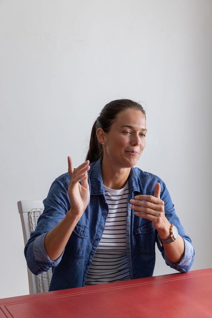 Confident Woman Communicating Ideas in Casual Meeting Setting