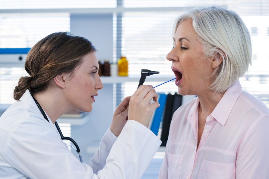 Doctor Examining Patient's Mouth with Otoscope - Free Images, Stock Photos and Pictures on Pikwizard.com