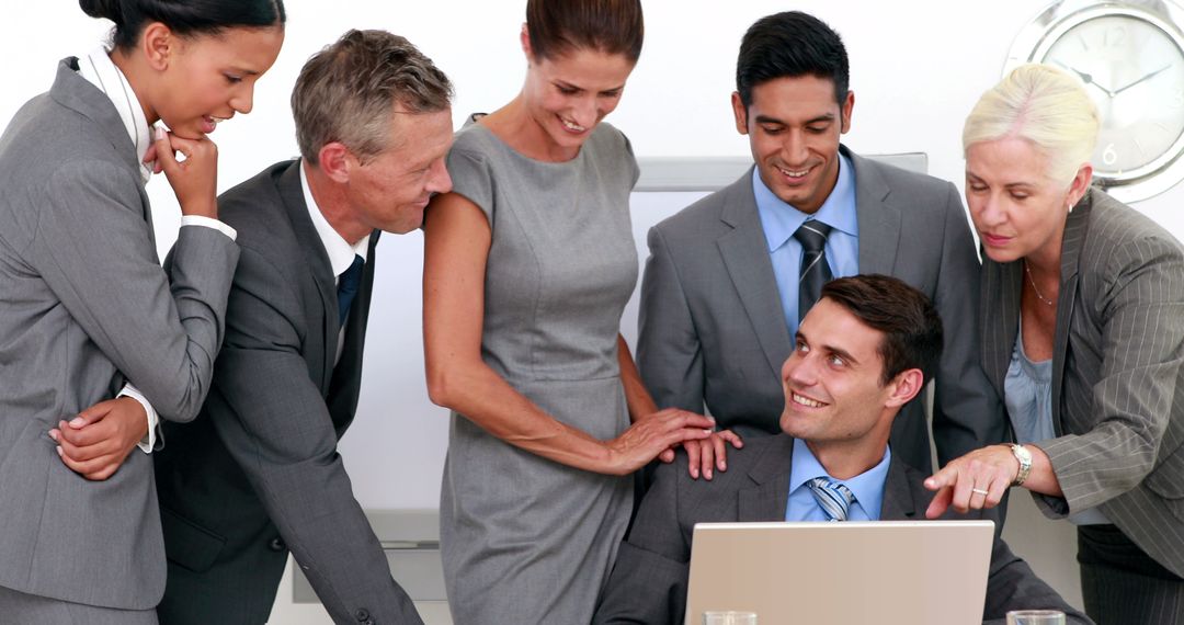 Diverse Business Team Meeting for Collaborative Discussion Around Laptop