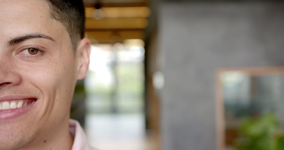 Close-Up of Smiling Young Man Indoors with Copy Space