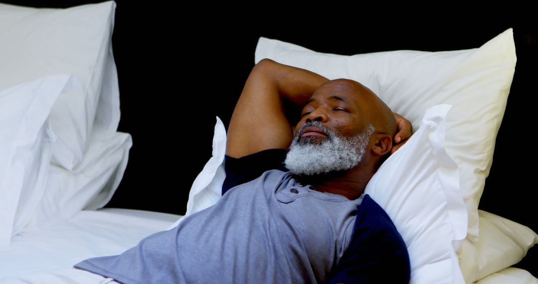 Mature African American Man Relaxing on Bed with Hands Behind Head - Free Images, Stock Photos and Pictures on Pikwizard.com