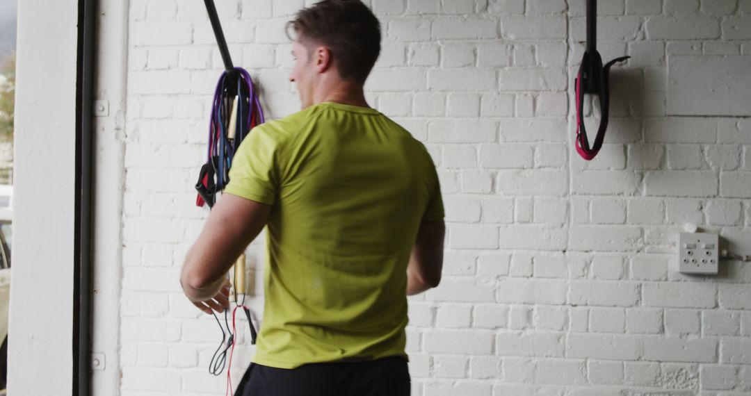 Man Exercising with Resistance Bands in Home Gym - Free Images, Stock Photos and Pictures on Pikwizard.com