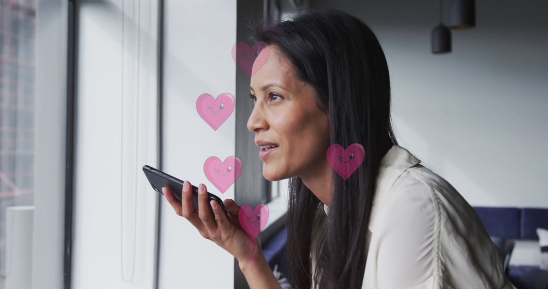 Professional Woman Using Smartphone Conversationally Near Window