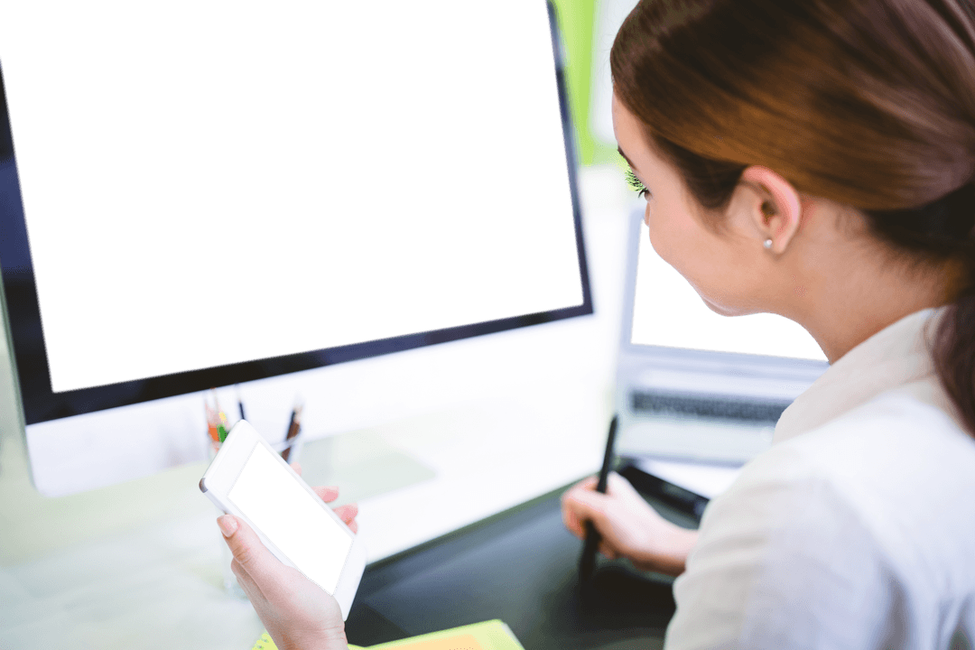 Businesswoman working with transparent screens using phone