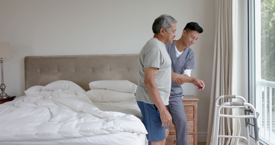 Caregiver assisting elderly man with walker in bedroom - Free Images, Stock Photos and Pictures on Pikwizard.com