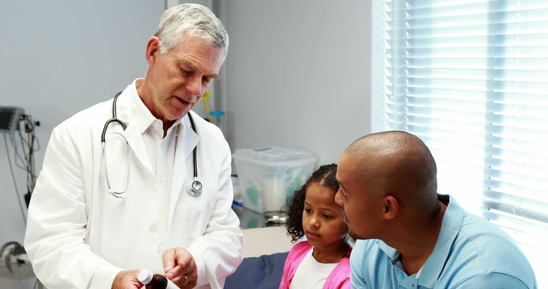 Doctor Explaining Prescription Medicine to Father and Young Daughter - Free Images, Stock Photos and Pictures on Pikwizard.com