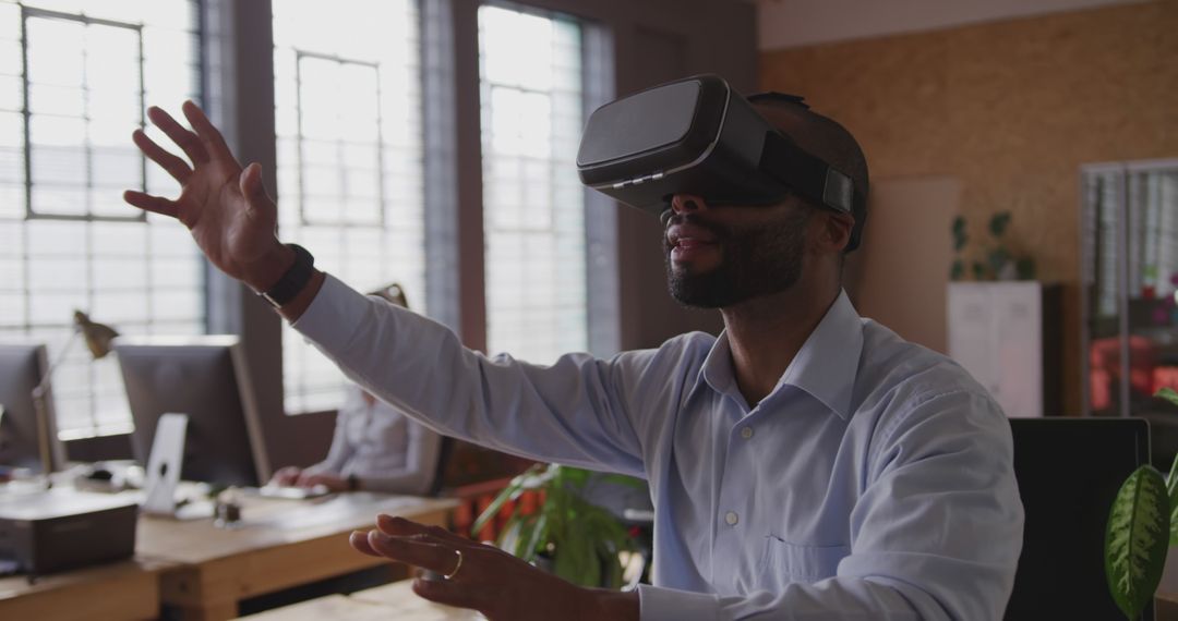 Businessman Exploring Virtual Reality in Modern Office Setup - Free Images, Stock Photos and Pictures on Pikwizard.com