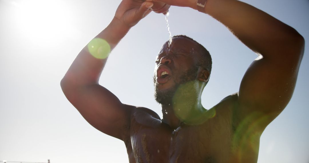 Athletic Black Man Pouring Water on Head During Workout Outdoors - Free Images, Stock Photos and Pictures on Pikwizard.com