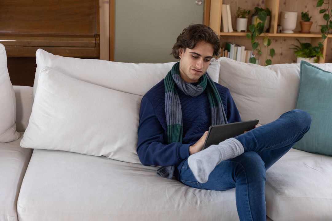 Man Enjoying Digital Reading in Cozy Home Environment