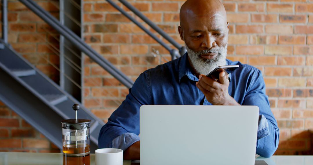 African American Man Using Voice Command on Smartphone in Modern Office - Free Images, Stock Photos and Pictures on Pikwizard.com