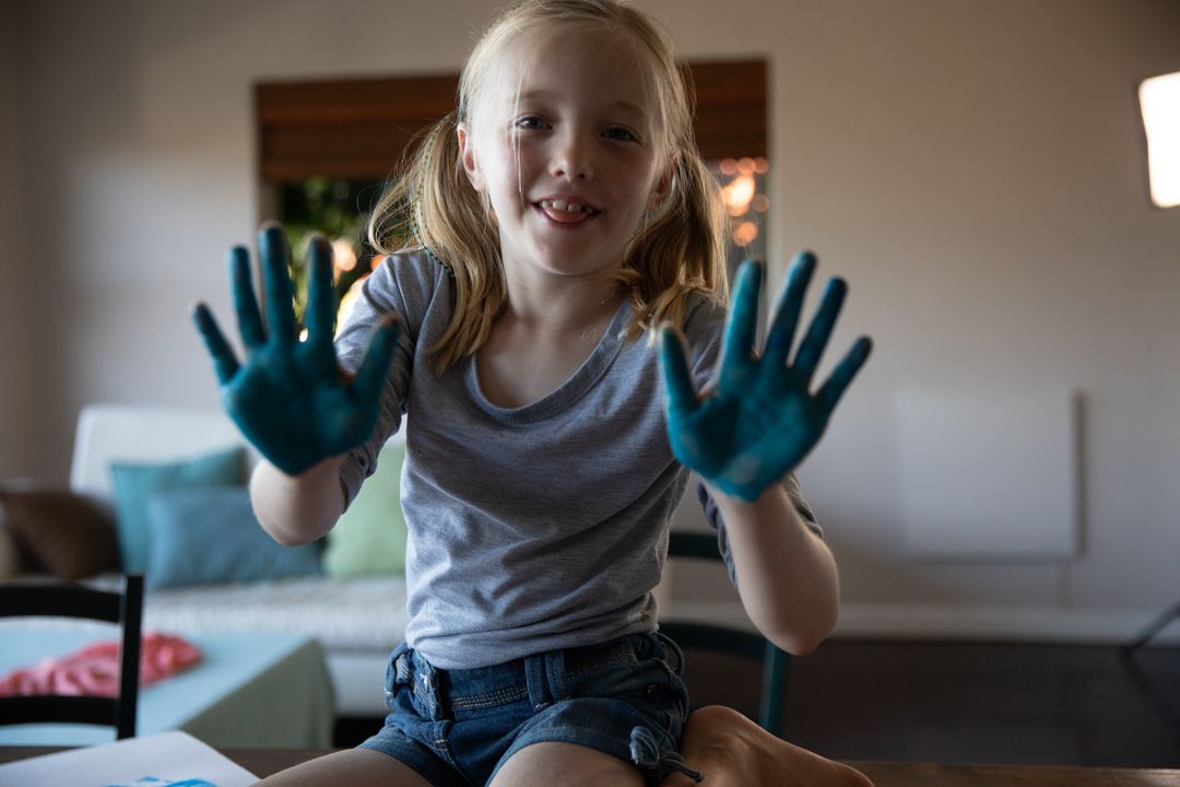Portrait of young girl with painted hands - Free Images, Stock Photos and Pictures on Pikwizard.com