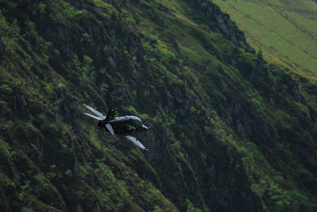 Military Jet Flying Low in Mountainous Terrain - Free Images, Stock Photos and Pictures on Pikwizard.com