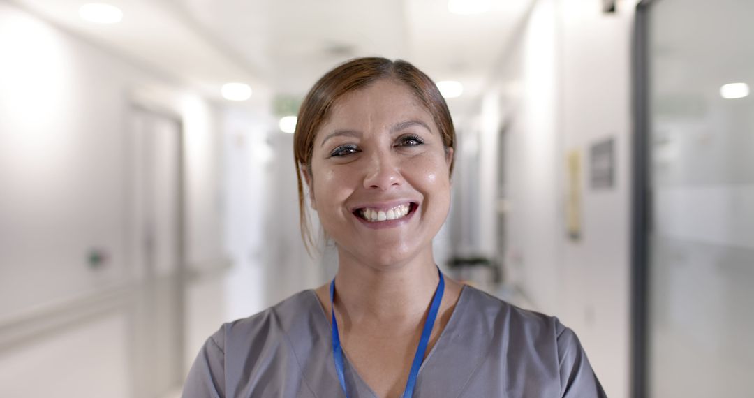 Smiling Healthcare Professional in Hospital Corridor - Free Images, Stock Photos and Pictures on Pikwizard.com