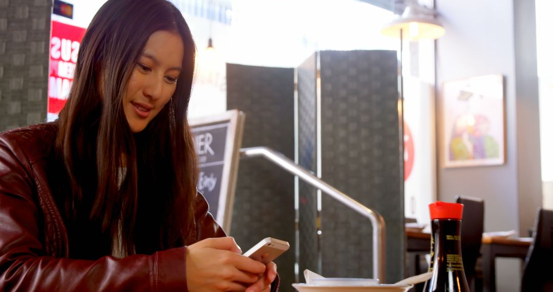 Woman Using Smartphone in Modern Cafe - Free Images, Stock Photos and Pictures on Pikwizard.com