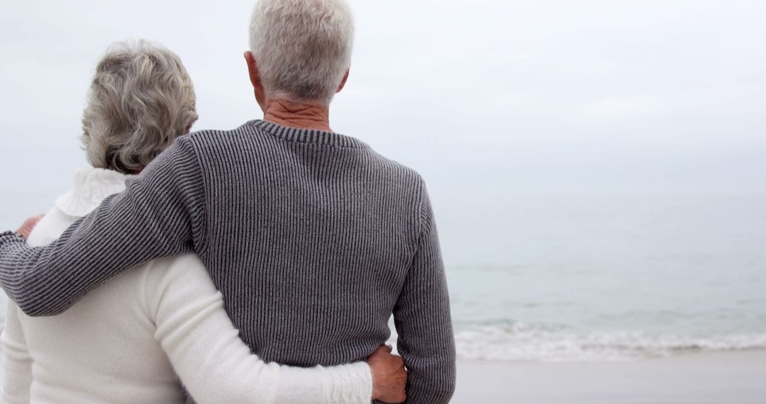 Senior Couple Embracing While Watching Ocean Waves