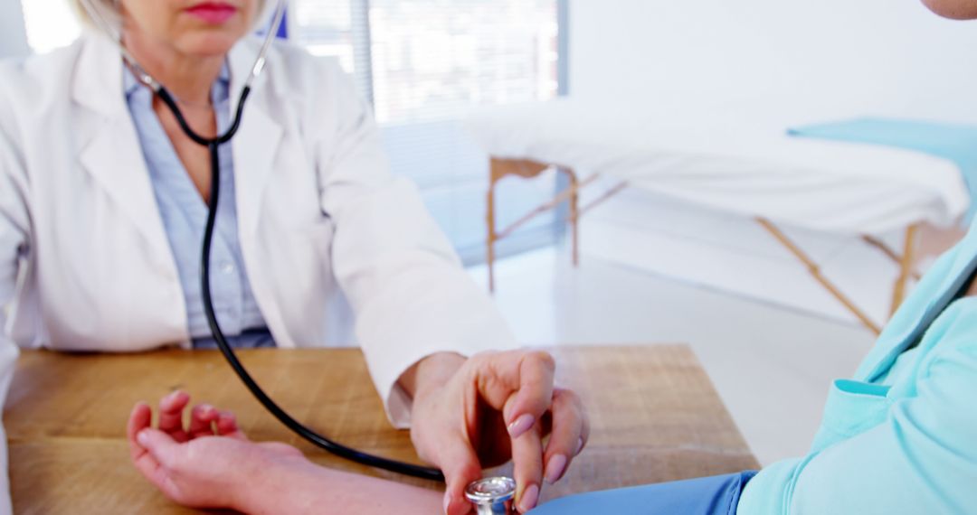 Doctor Checking Patient's Blood Pressure in Medical Office - Free Images, Stock Photos and Pictures on Pikwizard.com