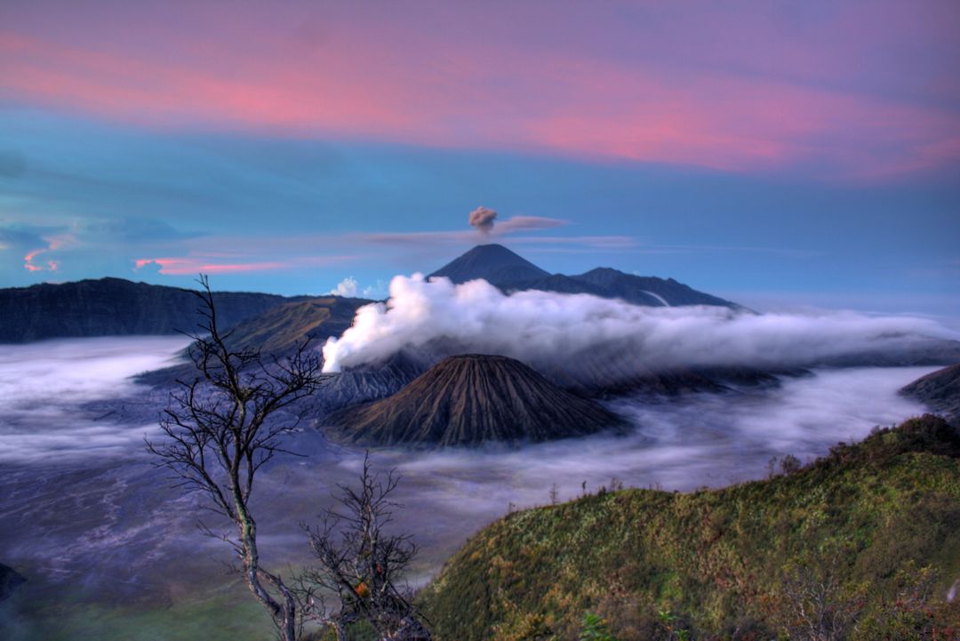 Mount Bromo at Sunrise with Smoke and Mist in East Java, Indonesia - Free Images, Stock Photos and Pictures on Pikwizard.com
