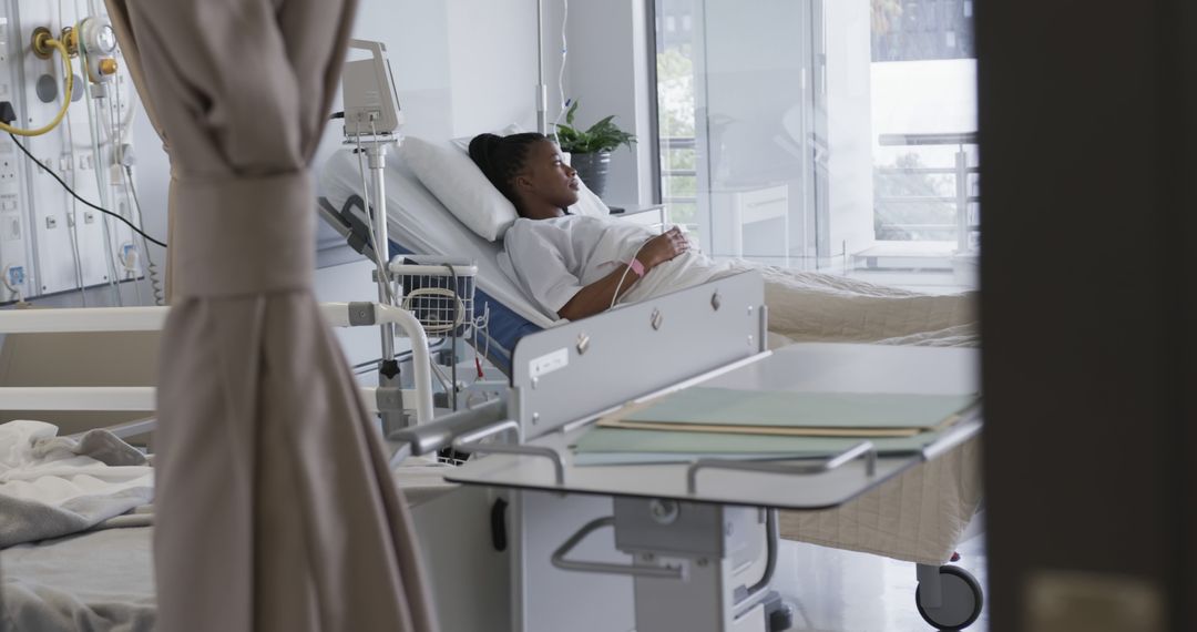 Patient Resting in Hospital Bed Receiving Medical Care - Free Images, Stock Photos and Pictures on Pikwizard.com