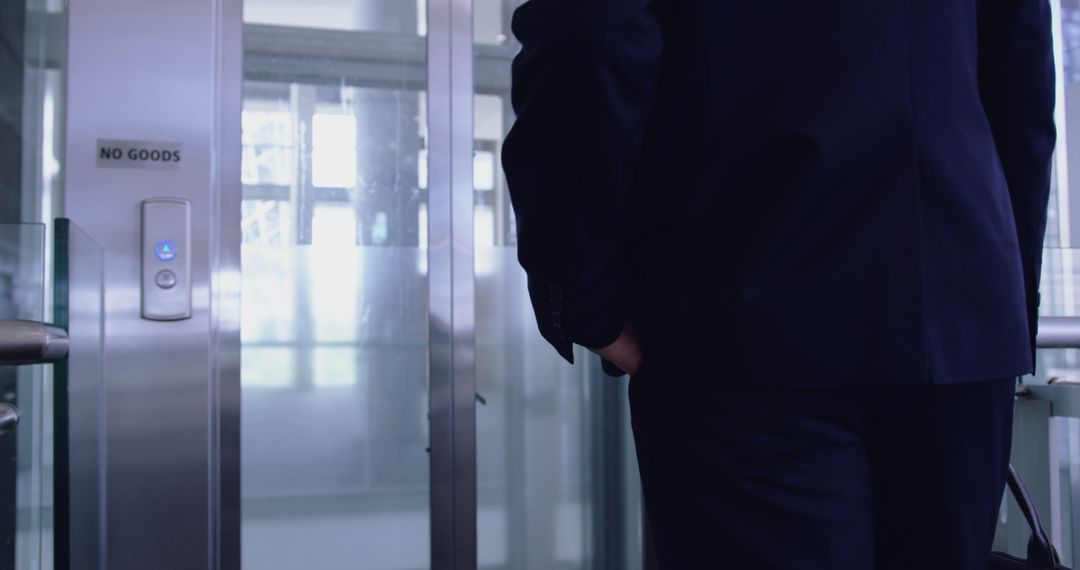 Businessman Waiting for Elevator in Modern Office Building - Free Images, Stock Photos and Pictures on Pikwizard.com