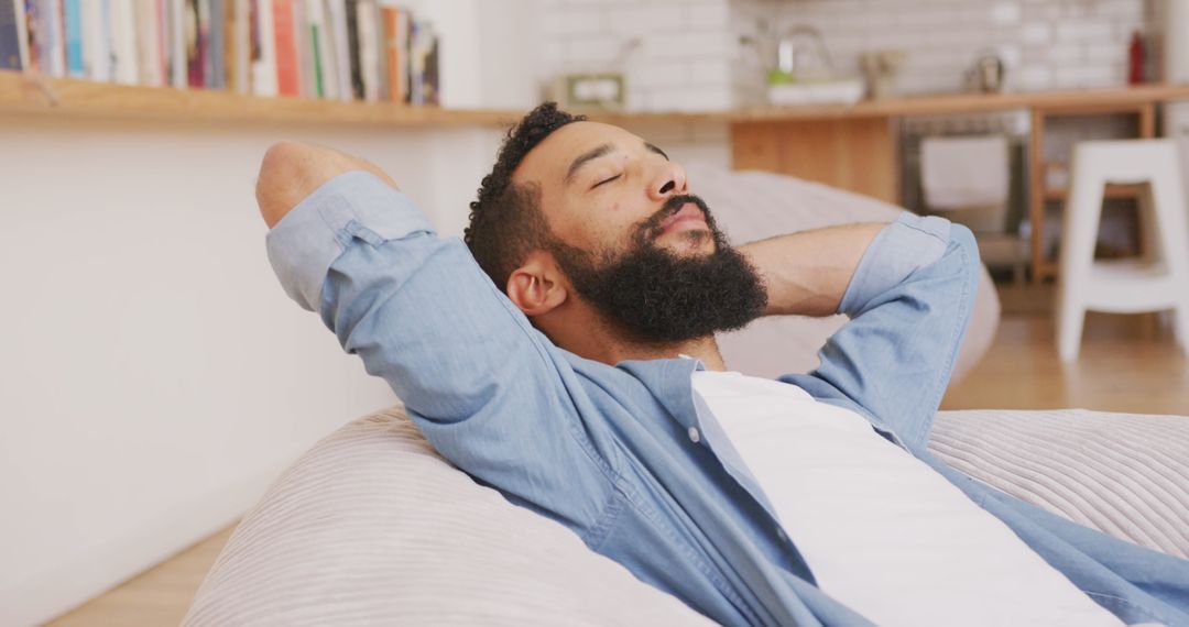 Man Relaxing at Home in Casual Settings with Closed Eyes
