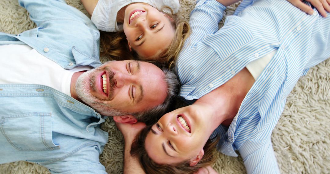 Happy Family Lying on Carpet, Smiling Together - Free Images, Stock Photos and Pictures on Pikwizard.com