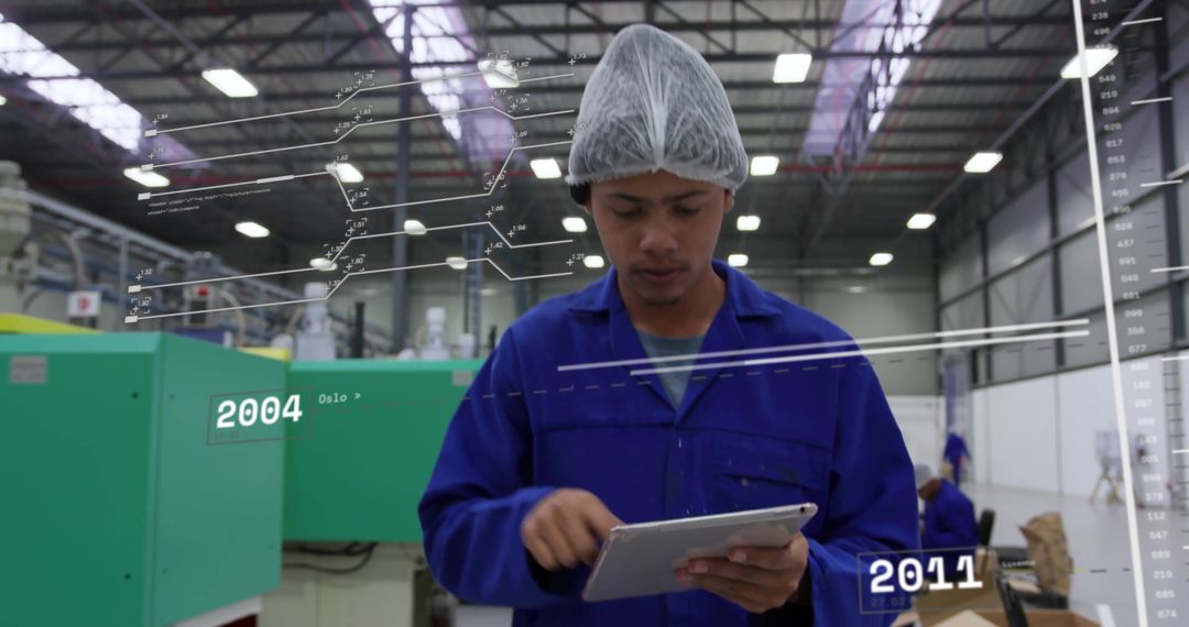 Technician Monitoring Machines Using Tablet in Factory Setting