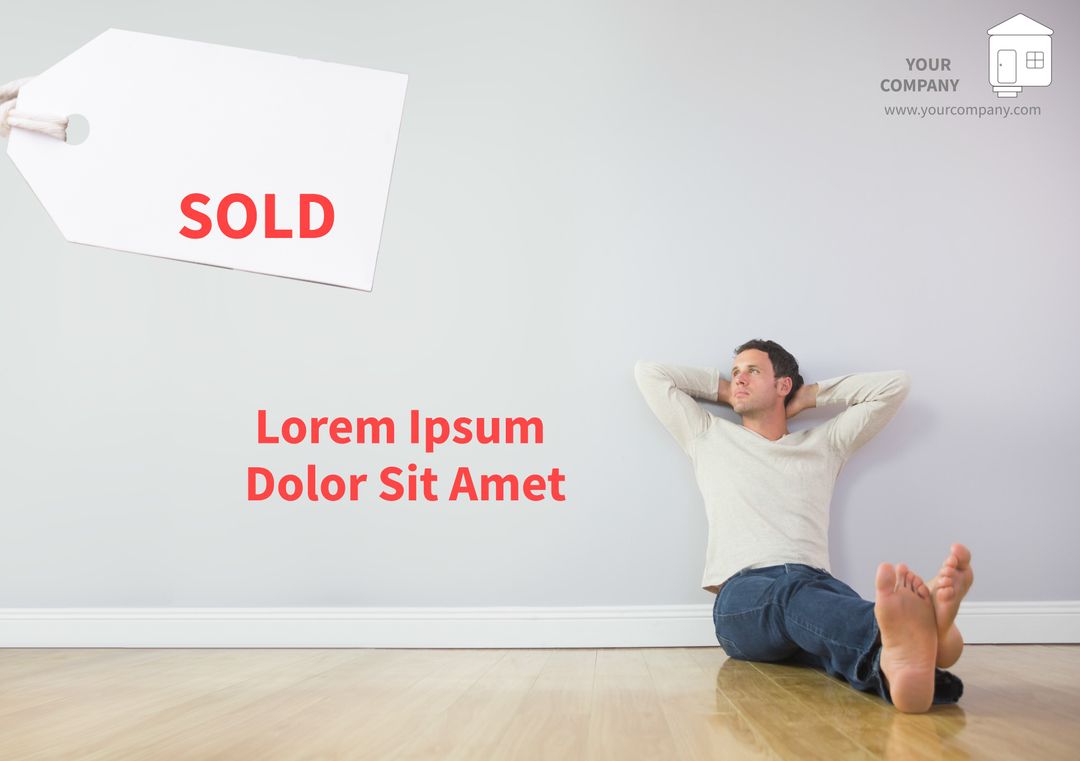 Man Relaxing in Empty Room with Sold Sign Representing Real Estate Success