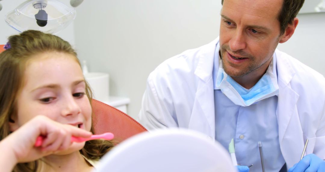 Female Child Learning Teeth Brushing Technique from Male Dentist - Free Images, Stock Photos and Pictures on Pikwizard.com