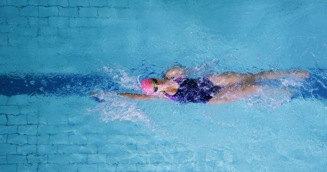 Professional Female Swimmer Performing Front Crawl in Swimming Pool - Free Images, Stock Photos and Pictures on Pikwizard.com