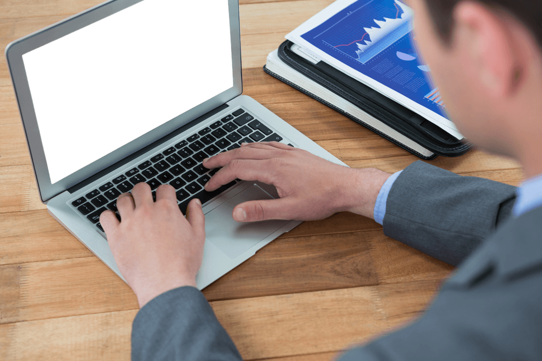Businessman Using Laptop with Transparent Screen in Office