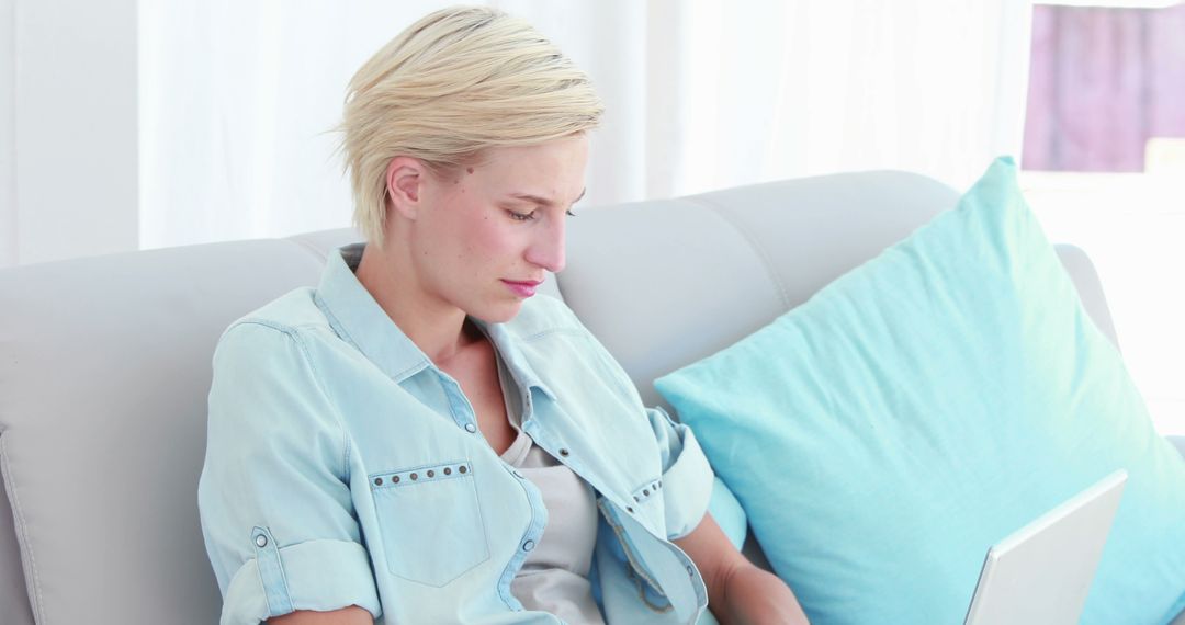 A young Caucasian woman appears focused while using a laptop, with copy space - Free Images, Stock Photos and Pictures on Pikwizard.com