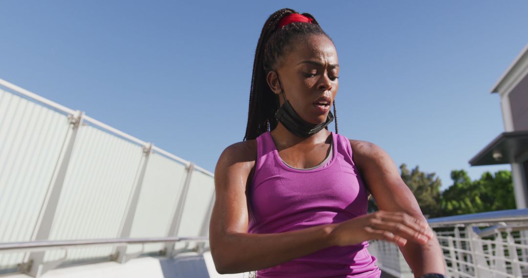 Female Athlete Adjusting Fitness Tracker During Outdoor Workout - Free Images, Stock Photos and Pictures on Pikwizard.com