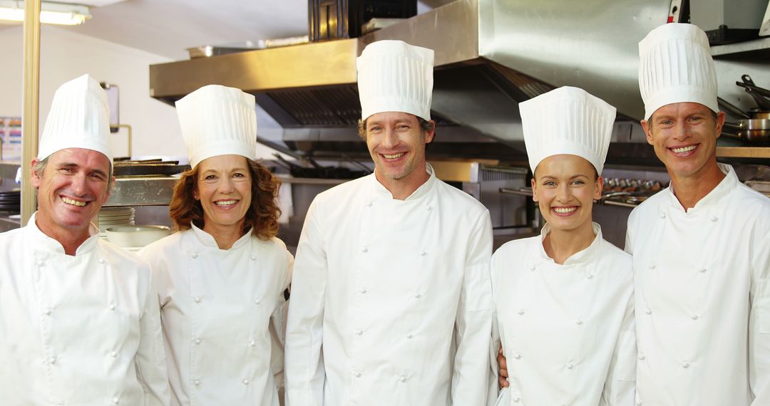 Group of Professional Chefs in Restaurant Kitchen Smiling - Free Images, Stock Photos and Pictures on Pikwizard.com