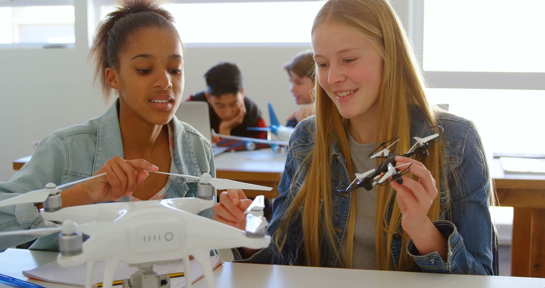 Two diverse teens collaborate on building a drone, highlighting hands-on tech education. - Free Images, Stock Photos and Pictures on Pikwizard.com