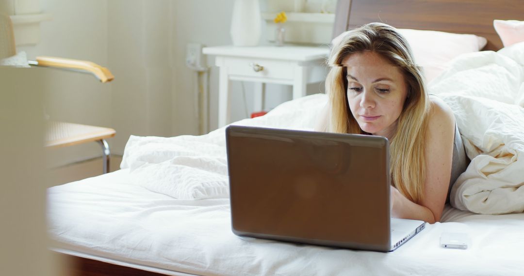 Woman Working on Laptop in Bed - Free Images, Stock Photos and Pictures on Pikwizard.com