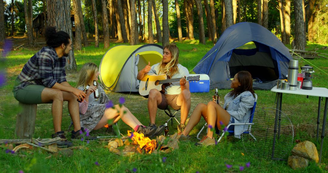 Friends Enjoying Music and Campfire in Forest - Free Images, Stock Photos and Pictures on Pikwizard.com