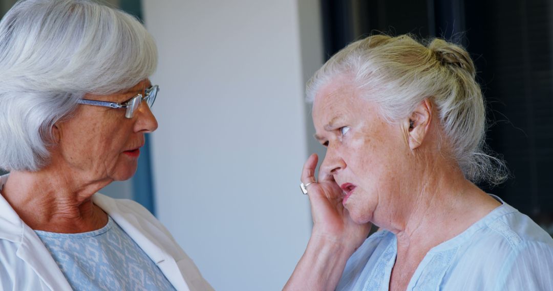 Doctor Comforting Worried Elderly Woman During Medical Visit - Free Images, Stock Photos and Pictures on Pikwizard.com