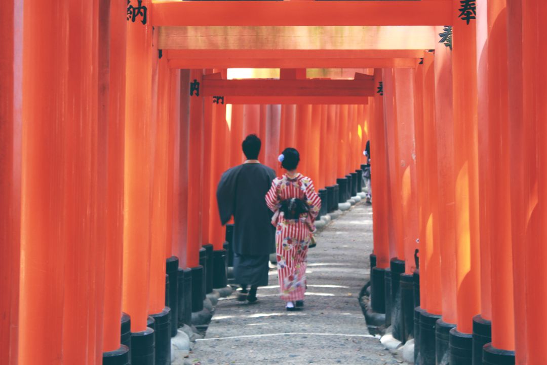 Couple Strolling Through Fushimi Inari Shrine Torii Gate Path in Kyoto, Japan - Free Images, Stock Photos and Pictures on Pikwizard.com