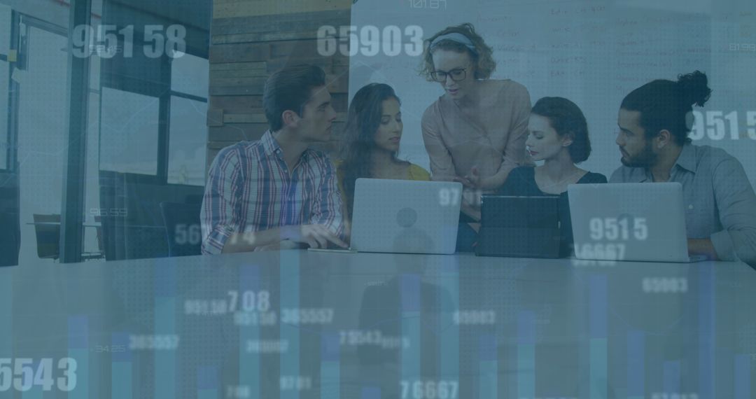 Diverse Team Analyzing Data with Technology in Modern Office