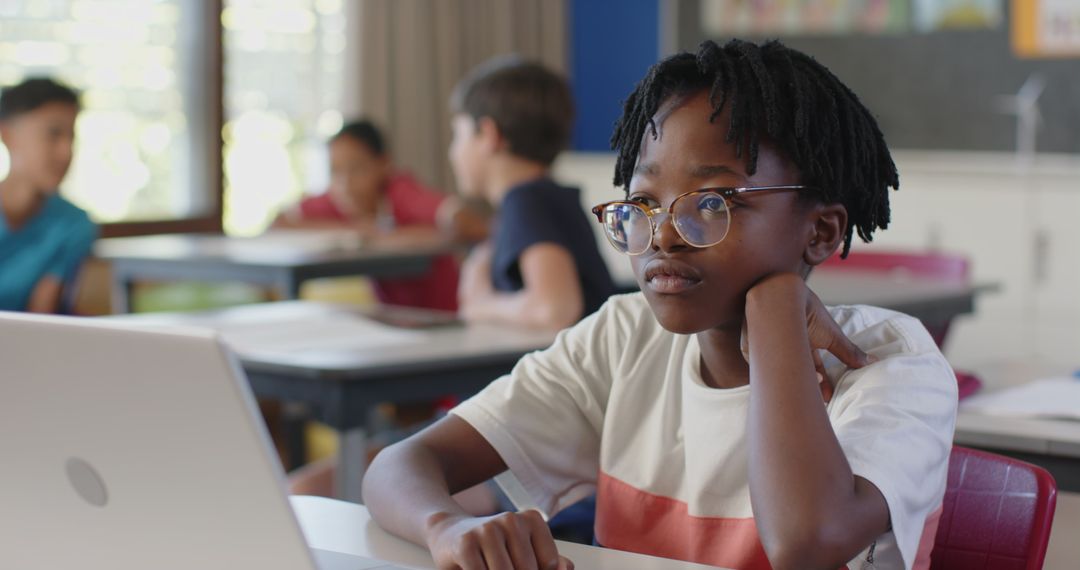 Focused Student Using Laptop in Classroom for Modern Learning