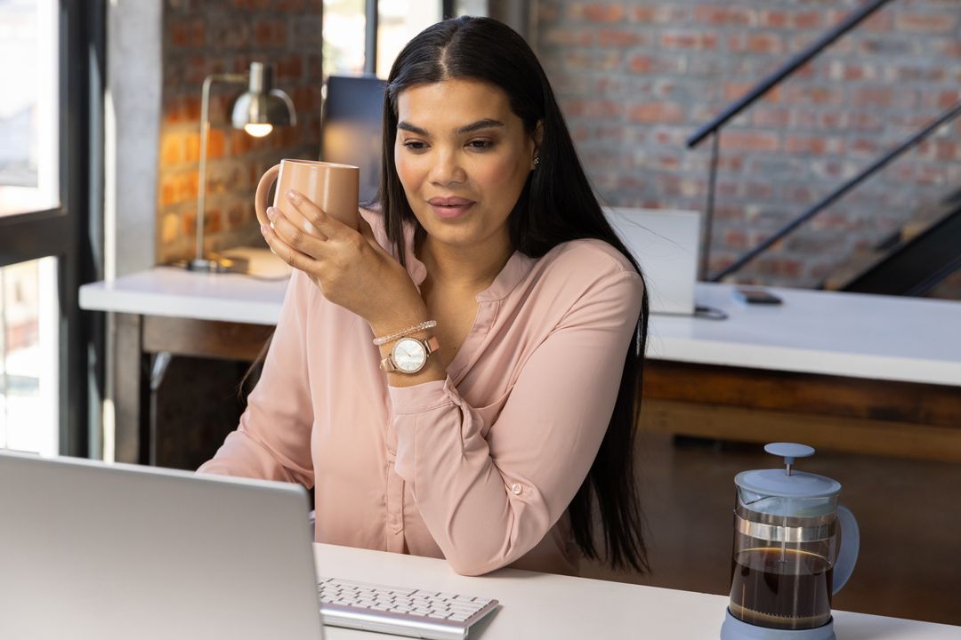 Professional Woman Enjoying Coffee in Loft Workspace for Productivity