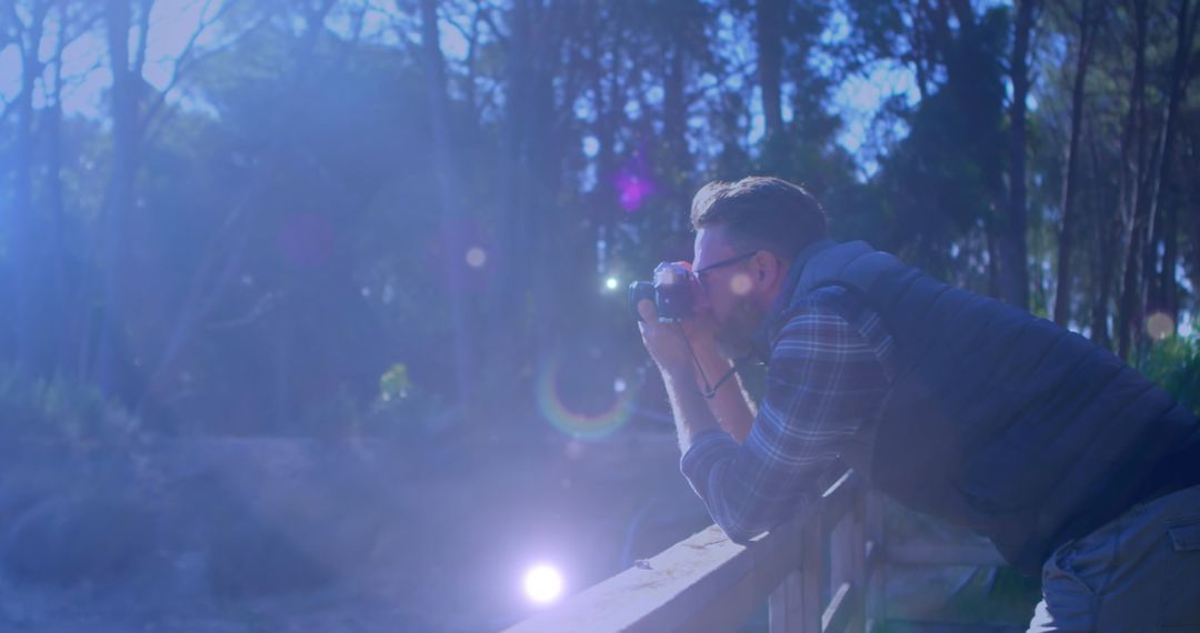 Photographer Capturing Nature's Beauty Among Sun Flares