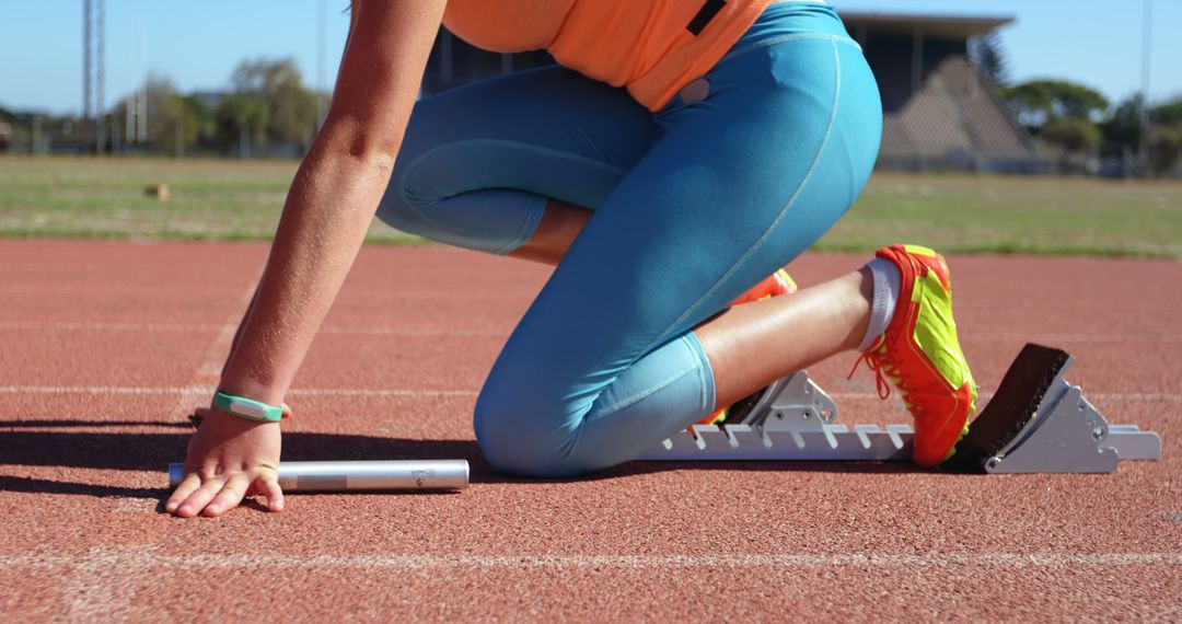 Female Sprinter Starting on Track with Block - Free Images, Stock Photos and Pictures on Pikwizard.com