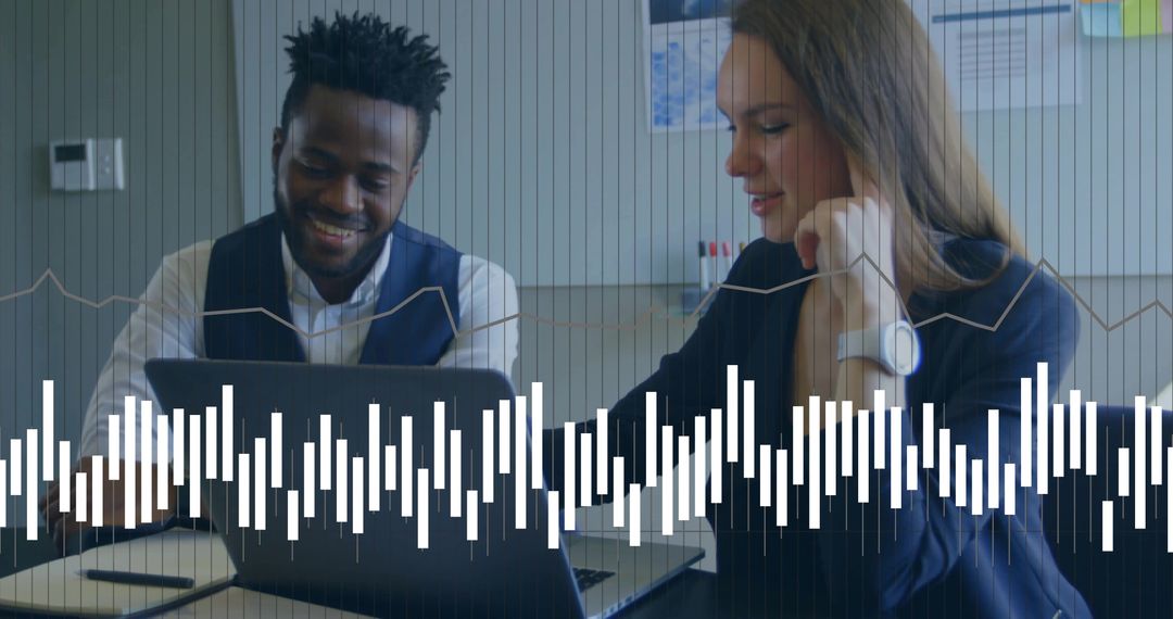 Business Colleagues Collaborating Over Laptop with Data Overlay