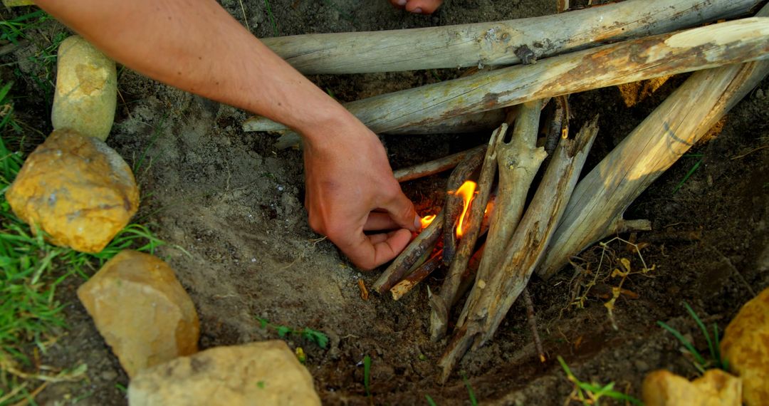 Person Lighting Campfire in Outdoor Setting - Free Images, Stock Photos and Pictures on Pikwizard.com